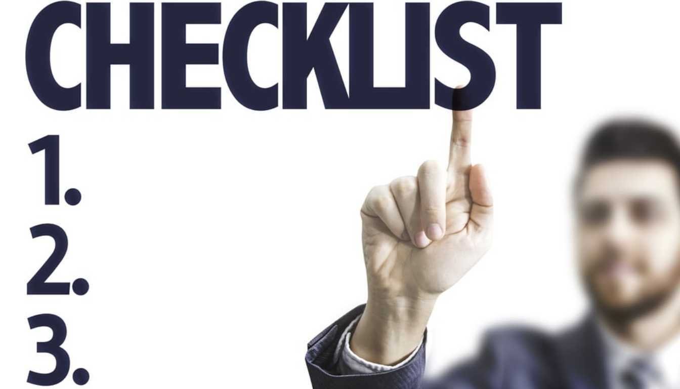 business man pointing towards checklist